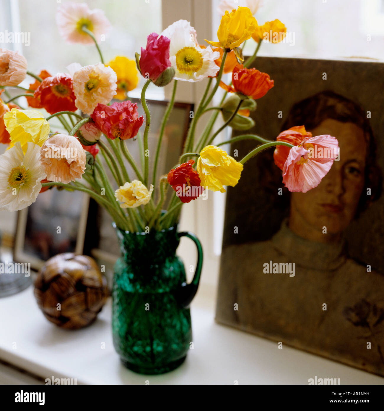 Tagliare fiori di primavera in una verde caraffa di vetro Foto Stock