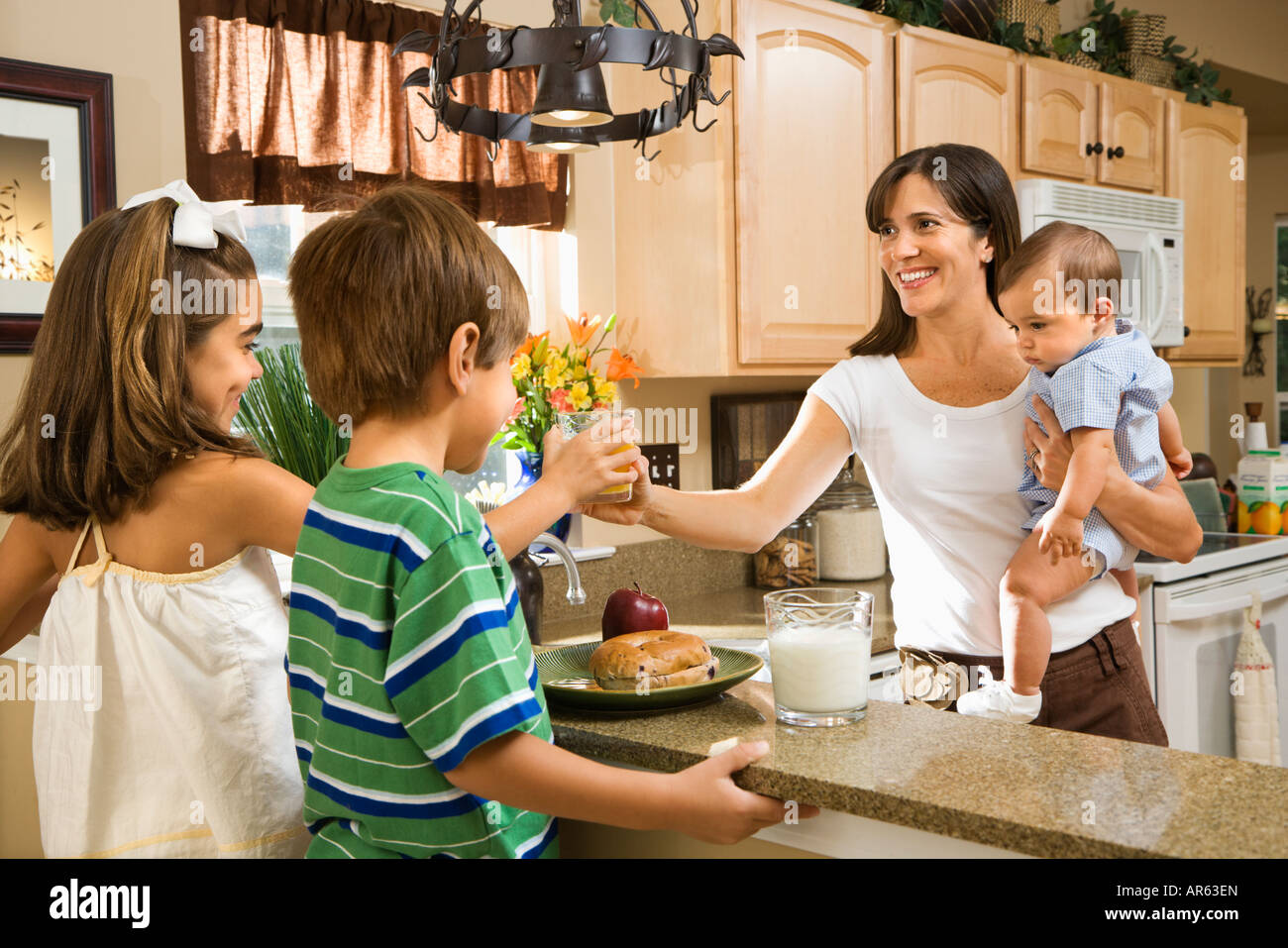 Famiglia di origine ispanica in cucina con prima colazione Foto Stock