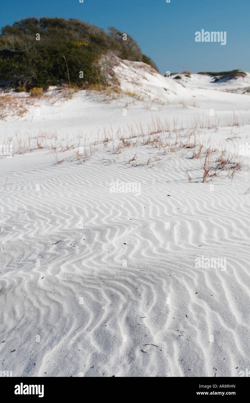 Le dune di sabbia bianca con erba colline coperte contro un cielo blu Foto Stock