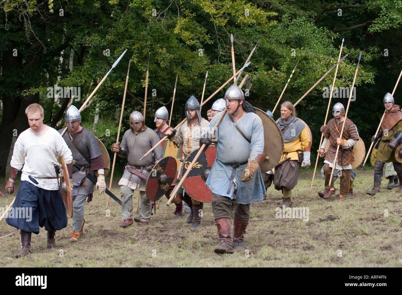 Guerrieri vichinghi con le lance e gli scudi di marciare in battaglia in una rievocazione festival Foto Stock