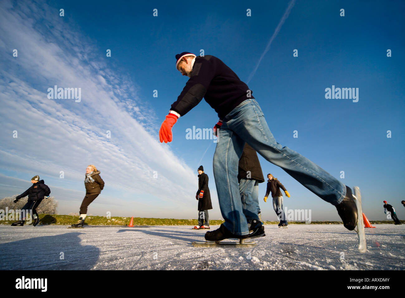 Un canale congelati in Olanda. Persone pattinaggio e imparare a pattinare. Foto Stock