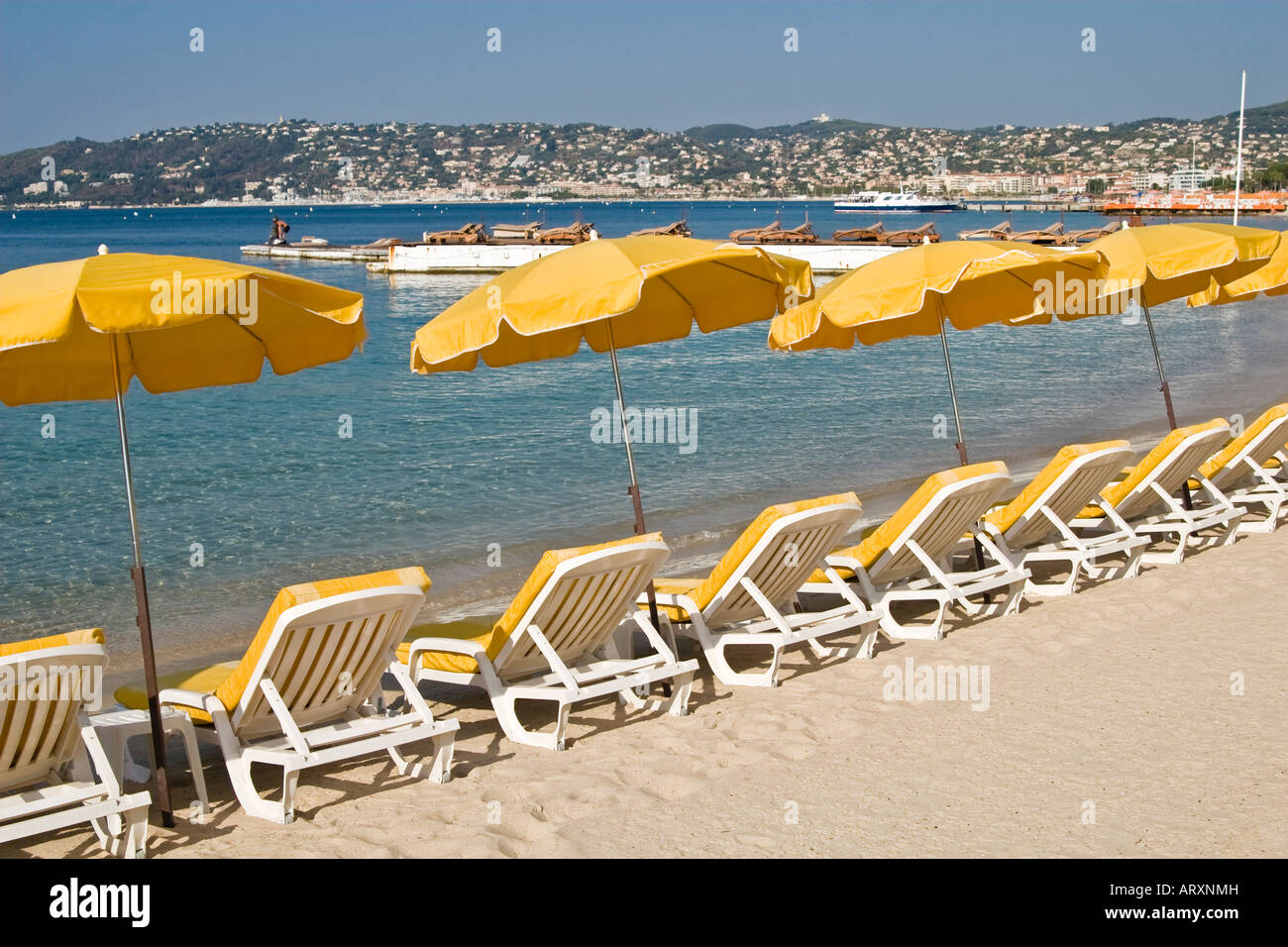 Costa Azzurra, vuoto spiaggia privata con fila di sdraio e ombrelloni, mattina Foto Stock