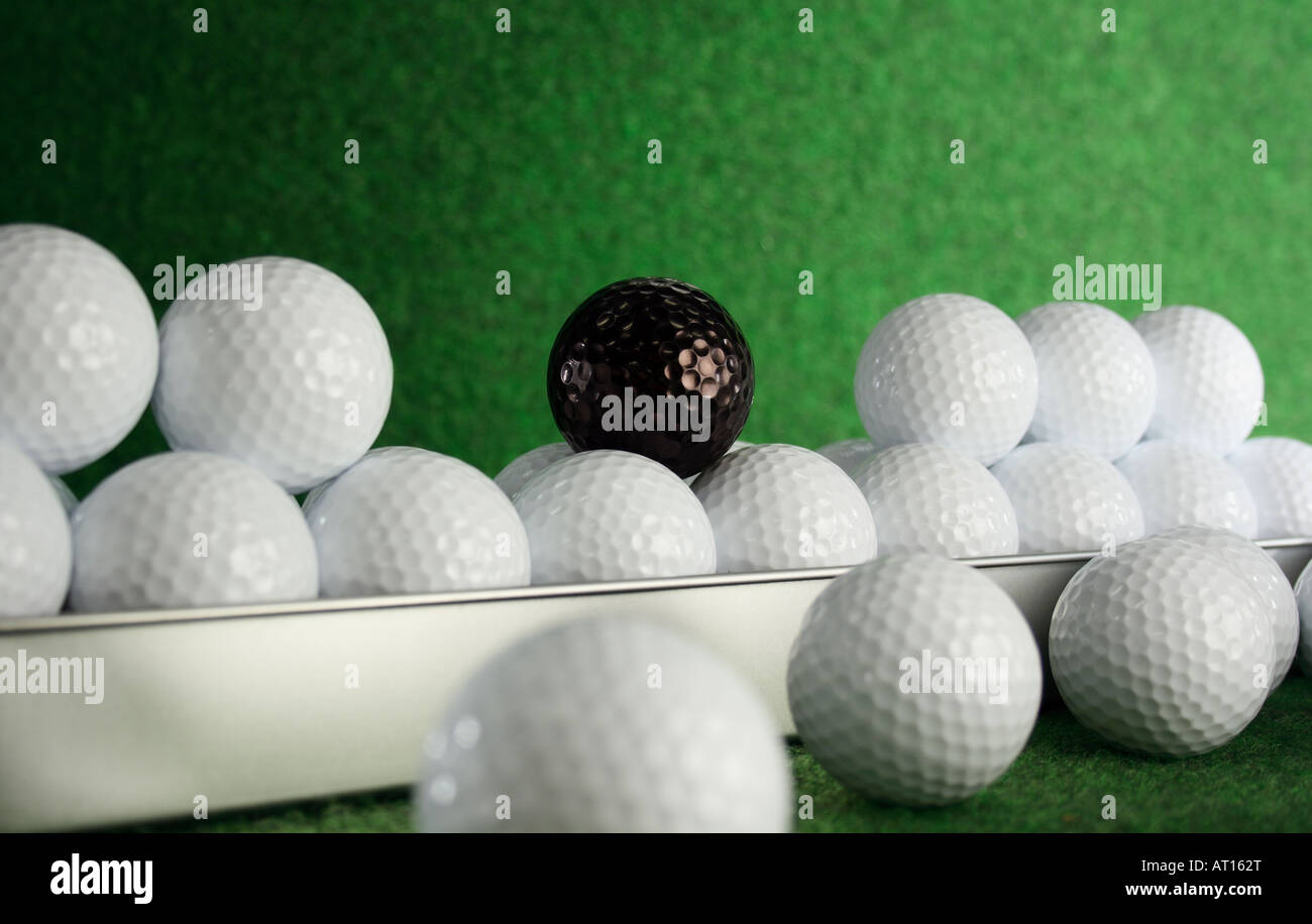 Golfballs nero con un joker tra di loro Foto Stock