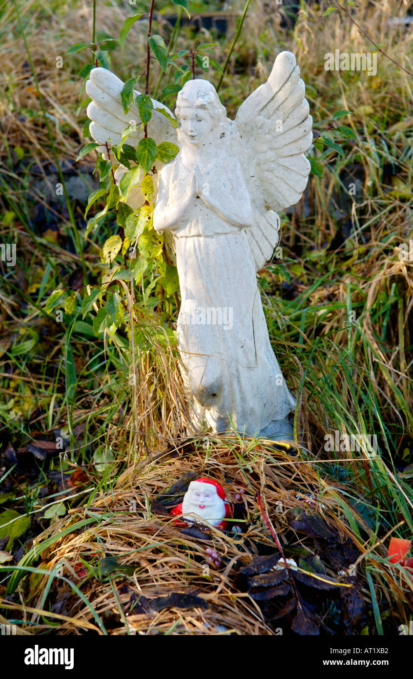 Angelo bianco e Babbo Natale su una tomba in Wales UK Foto Stock