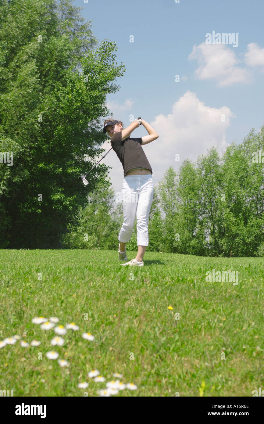 Frau nach Abschlag auf Golfrasen Foto Stock