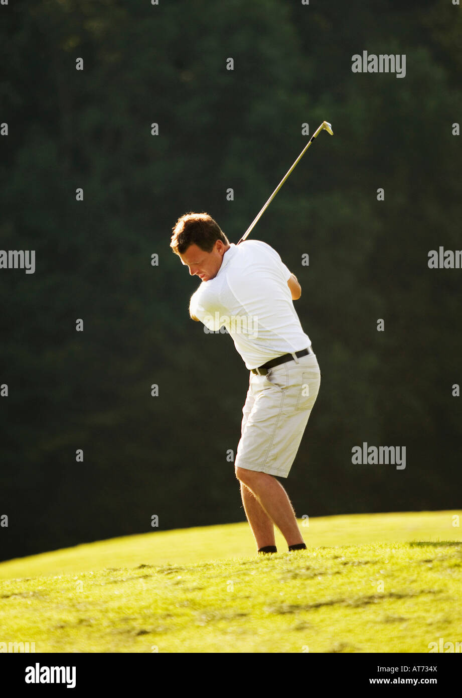 Austria, maschio golf club oscillante su fairway Foto Stock