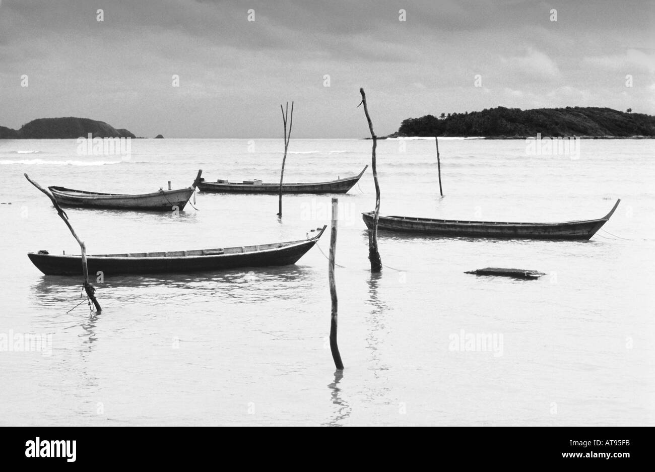Moody spiaggia con barche di Phuket Thailandia mono Foto Stock
