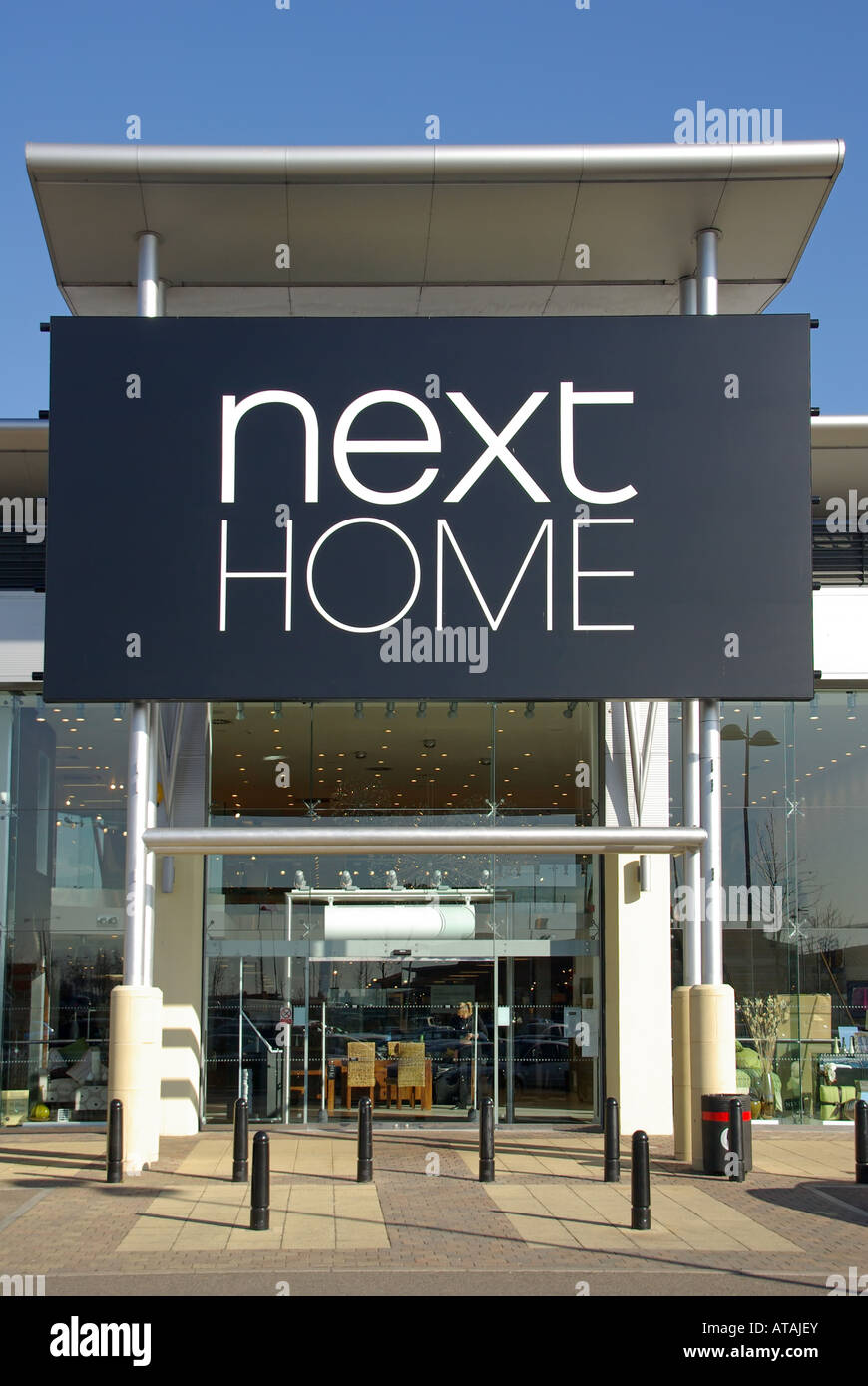 Next Home store segno e tettoia sopra l'ingresso al Lago fuori città retail park complesso per lo shopping Foto Stock