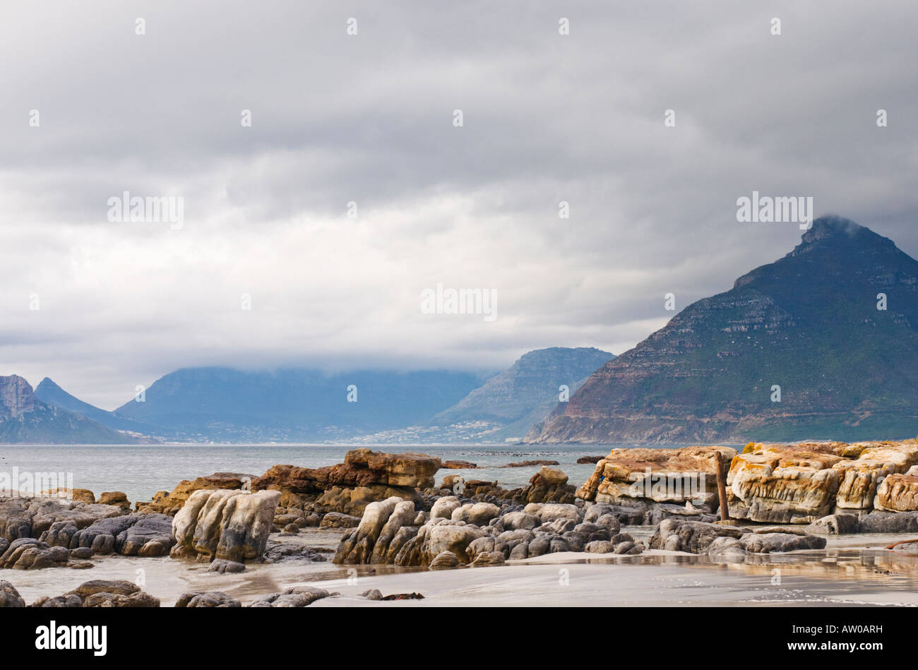 Rocce e massi sulla lunga spiaggia Kommetjie Penisola del Capo Sud Africa Foto Stock