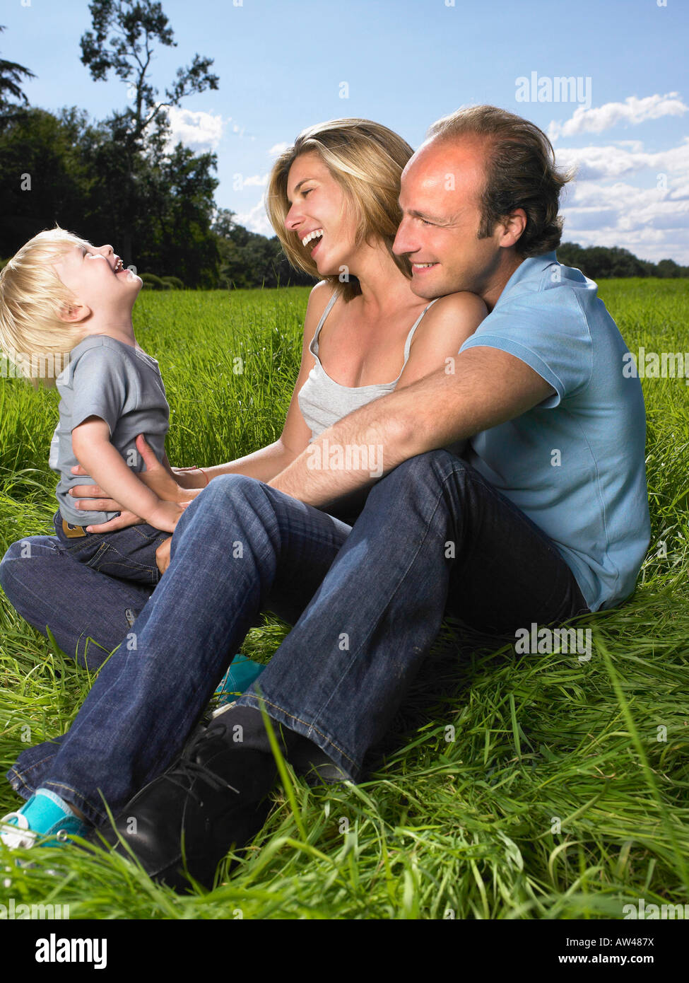 La famiglia che gode di una buona volta in un campo. Foto Stock