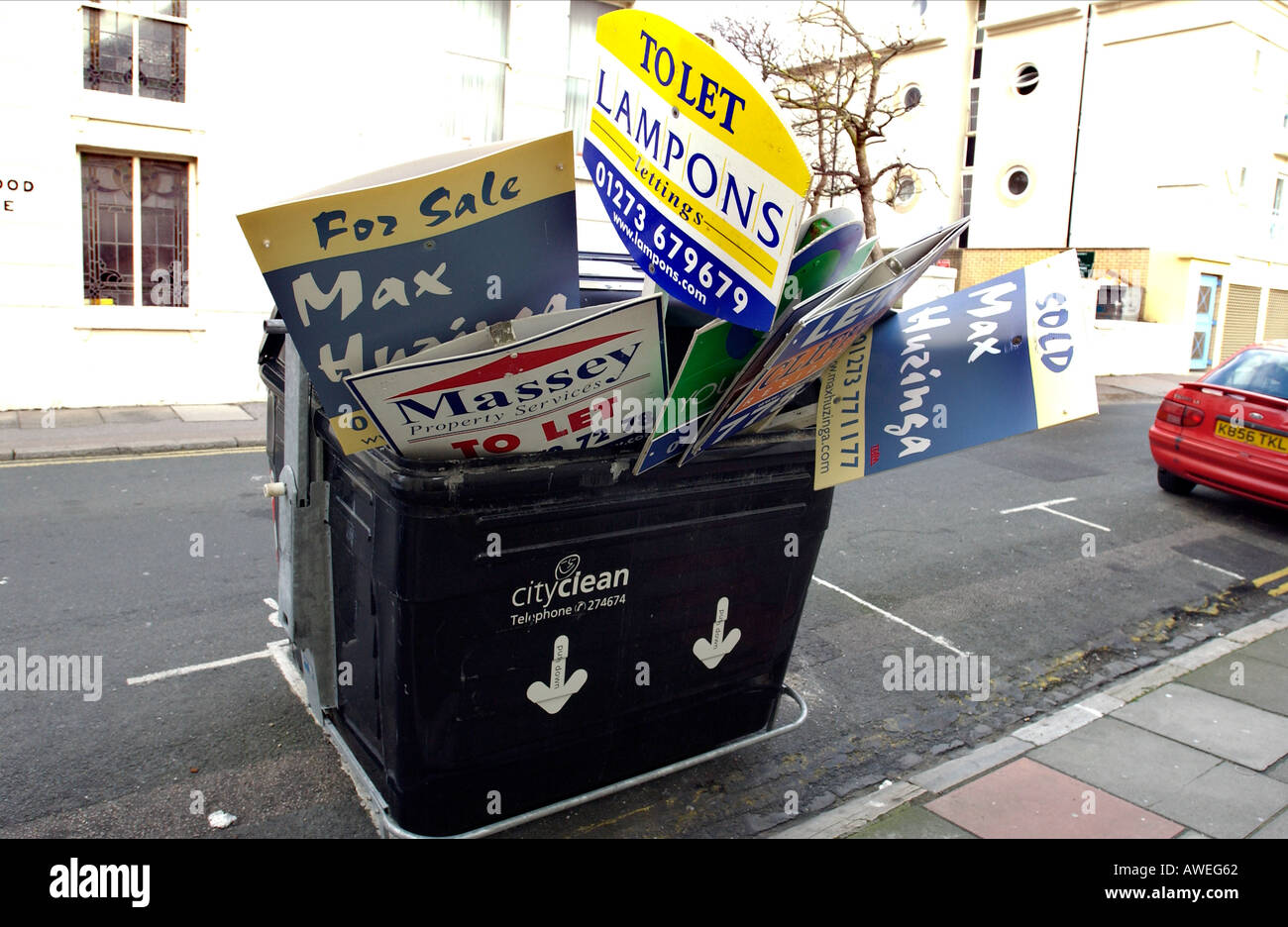 Scartato Casa in vendita o di lasciare segni sono stipati in un Brighton e Hove City Council communal bidone dei rifiuti Foto Stock