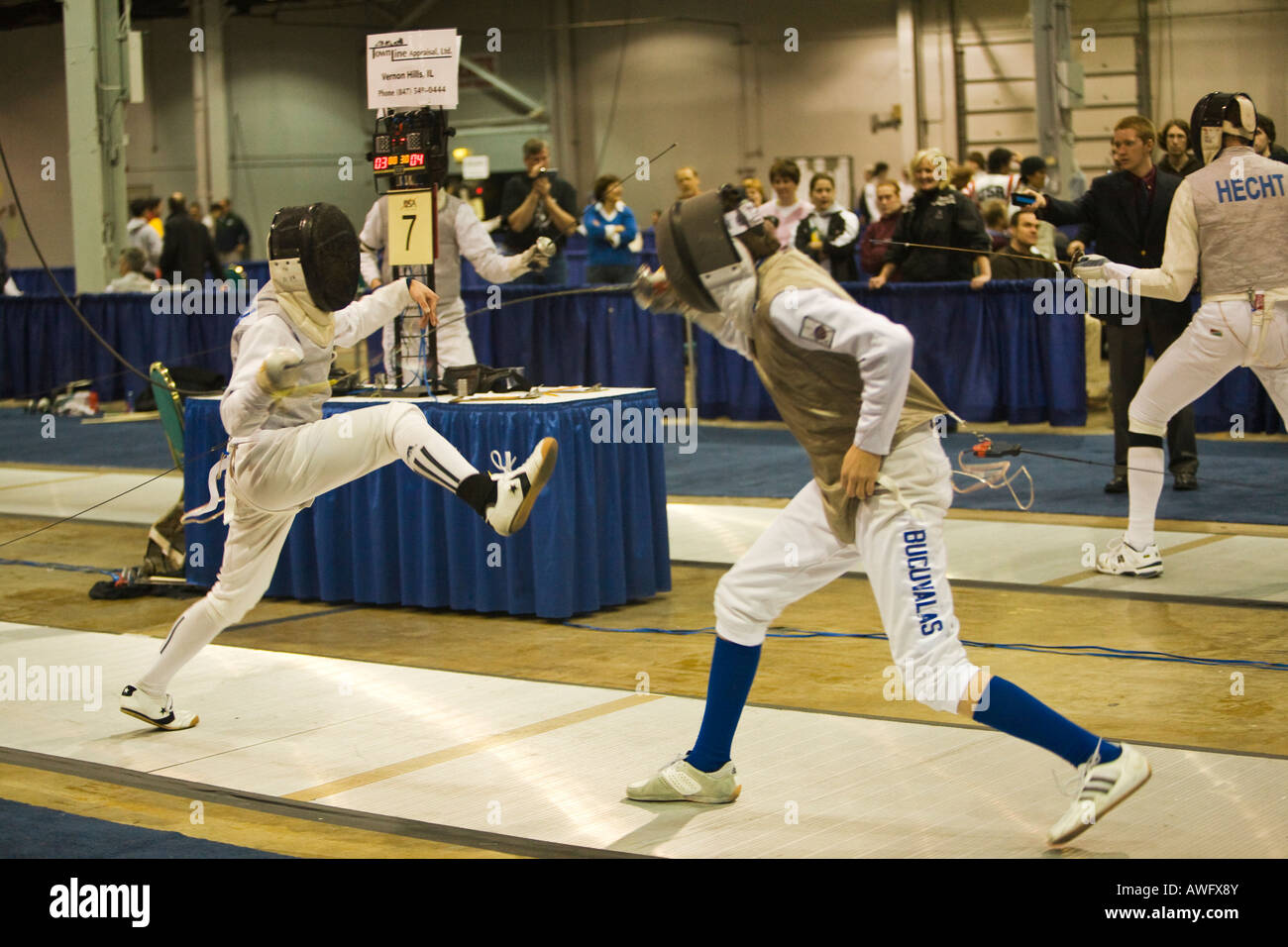 Sport di competizione di scherma bout maschio concorrenti di lamina su nastro durante il match uomo affondo verso l'avversario Foto Stock