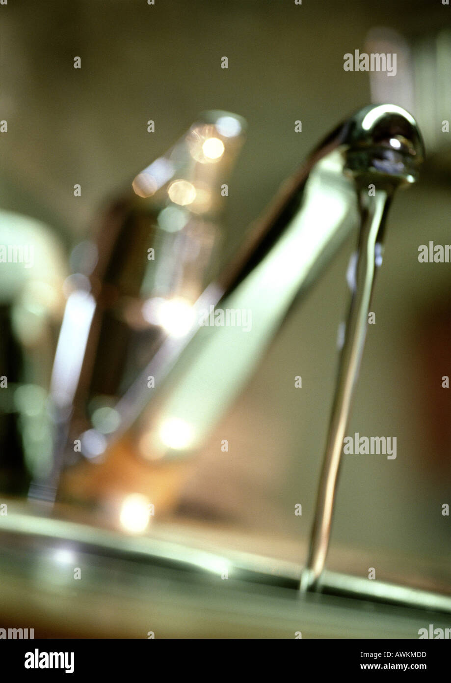 L'acqua che scorre dal rubinetto, close-up, sfocato Foto Stock