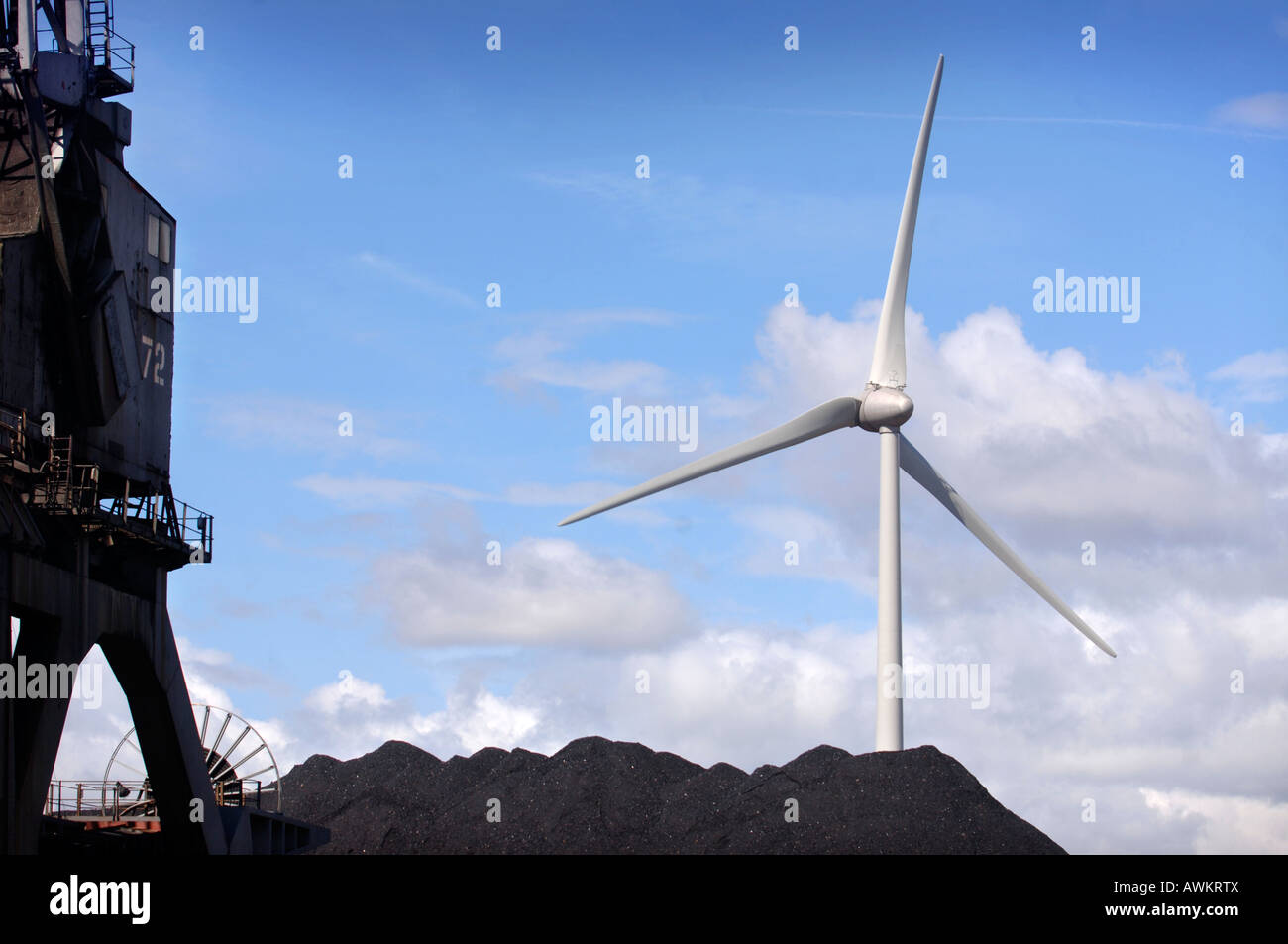 Una turbina eolica situato accanto a un deposito di carbone con un getto FLYING OVERHEAD A PORTA AVONMOUTH vicino a Bristol Regno Unito 2007 Foto Stock