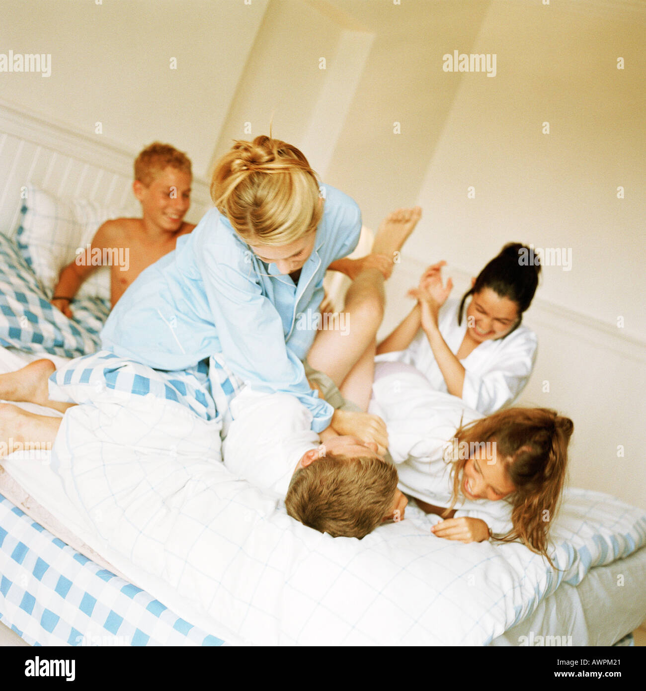 Giovani playfighting sul letto Foto Stock