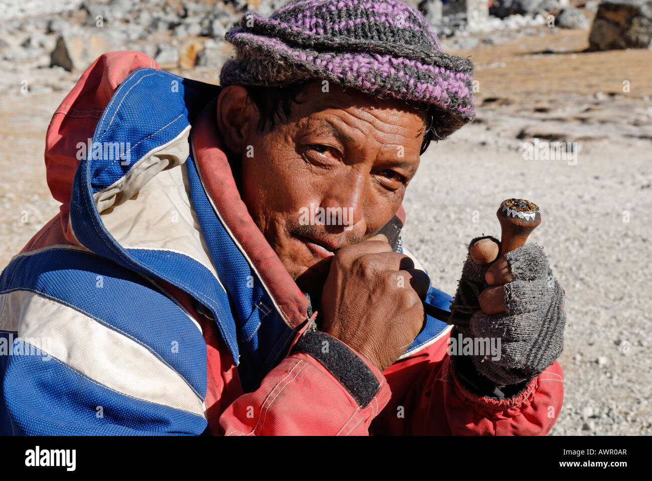 Sherpa uomo fumare una tubazione, Khumbu Himal, Parco Nazionale di Sagarmatha, Nepal Foto Stock