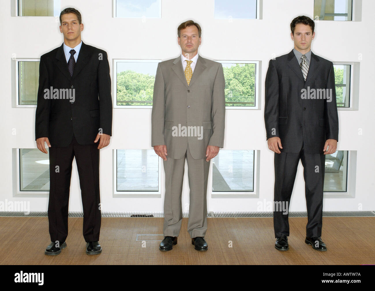 Tre uomini di affari in piedi in una linea Foto Stock