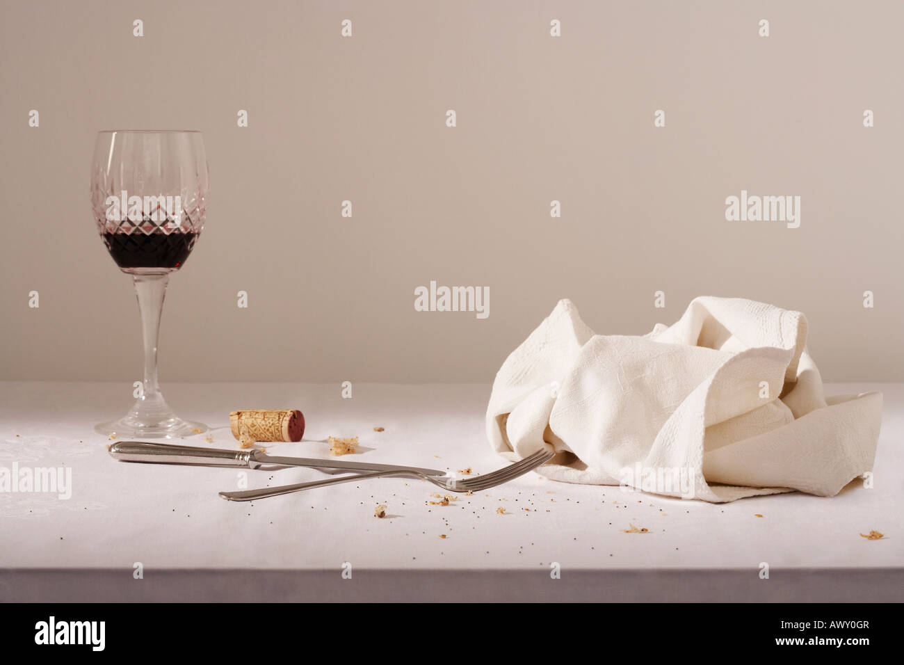 Bicchiere da vino, posate, canovaccio sul tavolo disordinato Foto Stock