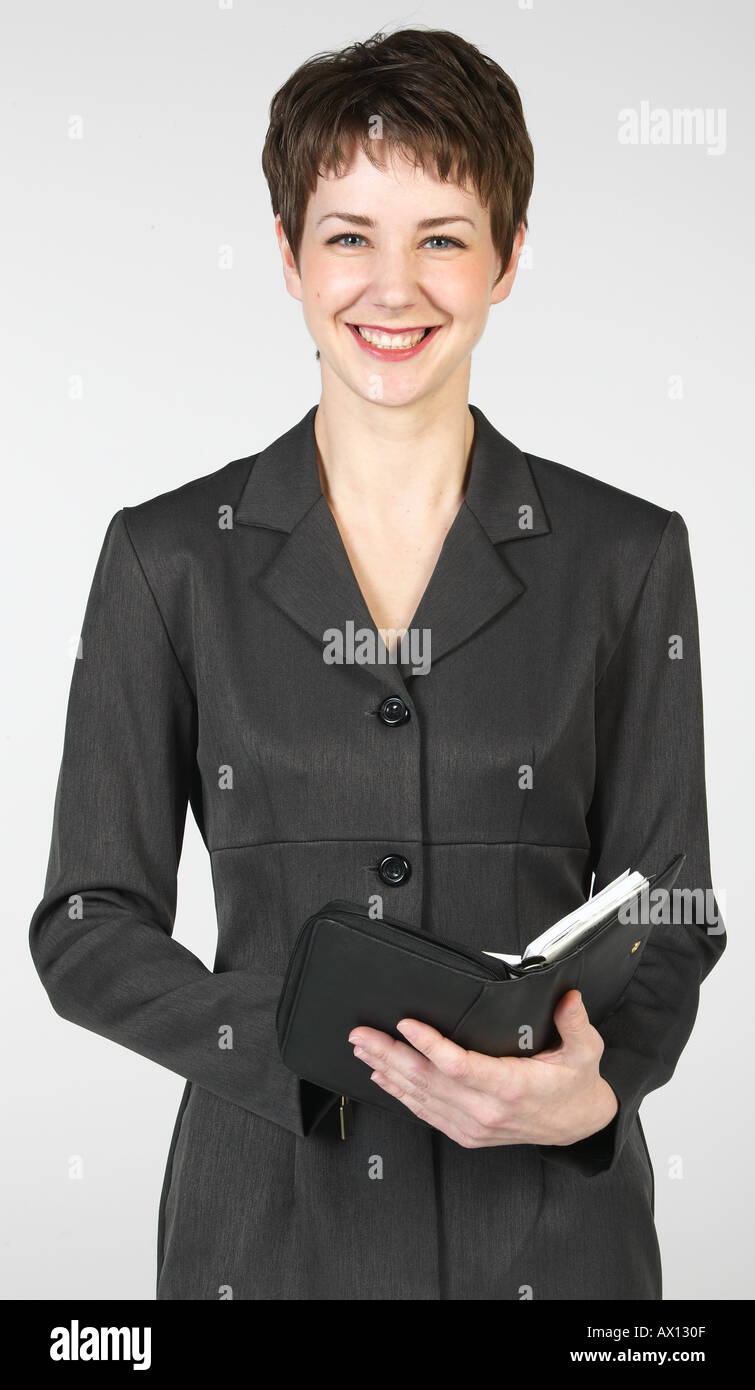 Sorridente imprenditrice azienda open day planner Foto Stock