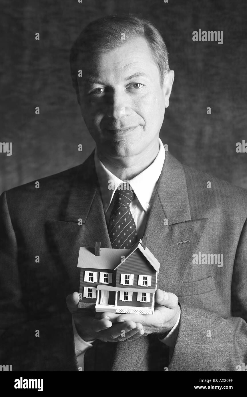 Uomo con modello di casa di essere 5 Foto Stock