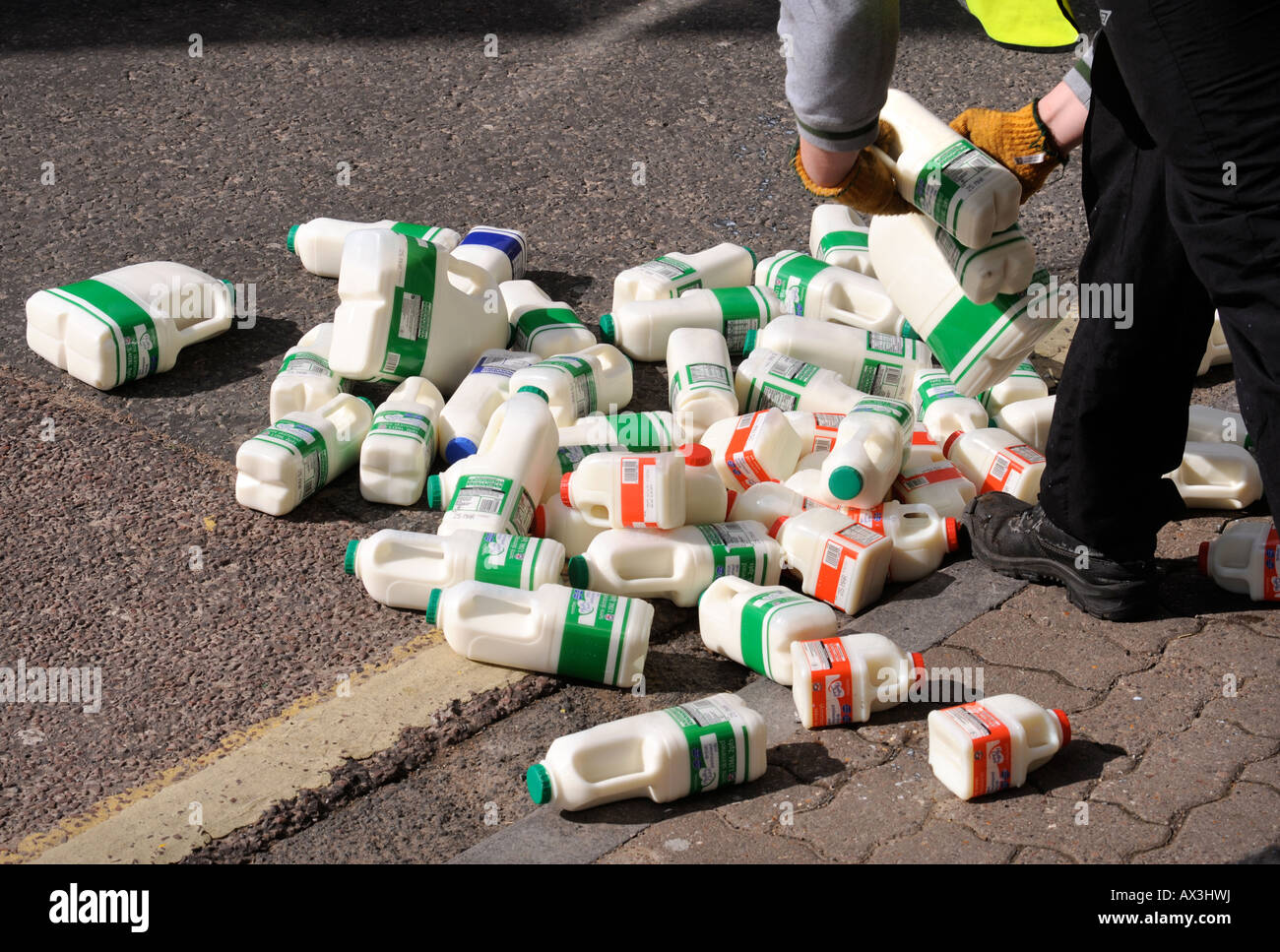 Una pila di contenitori di latte è scesa al di fuori di un Supermercato UK Foto Stock