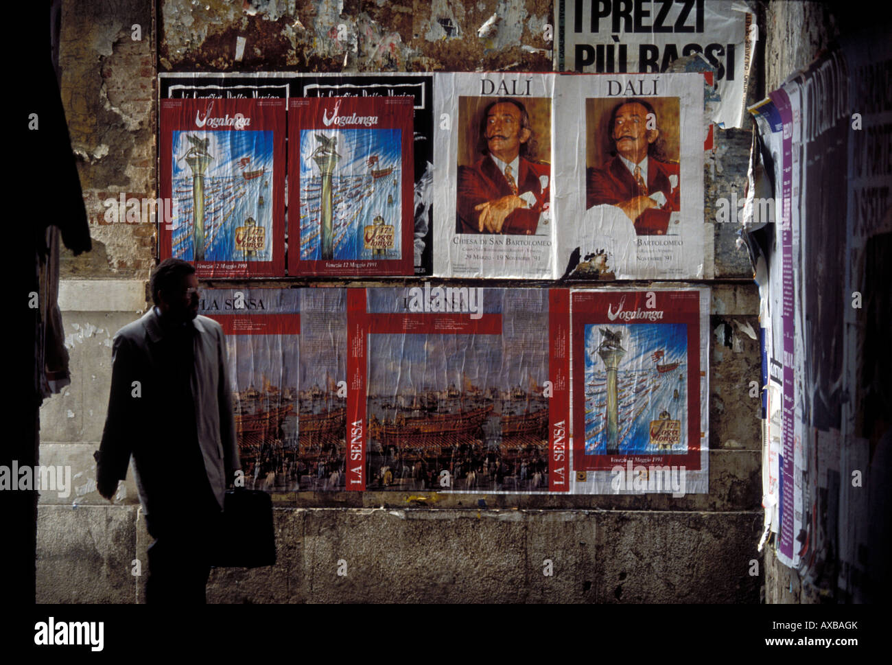 Persona che cammina su una strada con poster outdoor, Venezia, Italia Foto Stock