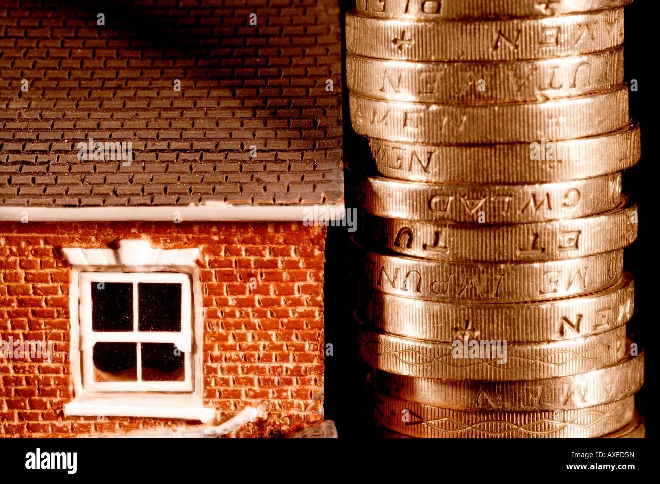 Una casa in vendita affondato in debito alle prese con la recessione out-pesati da British pound monete Foto Stock