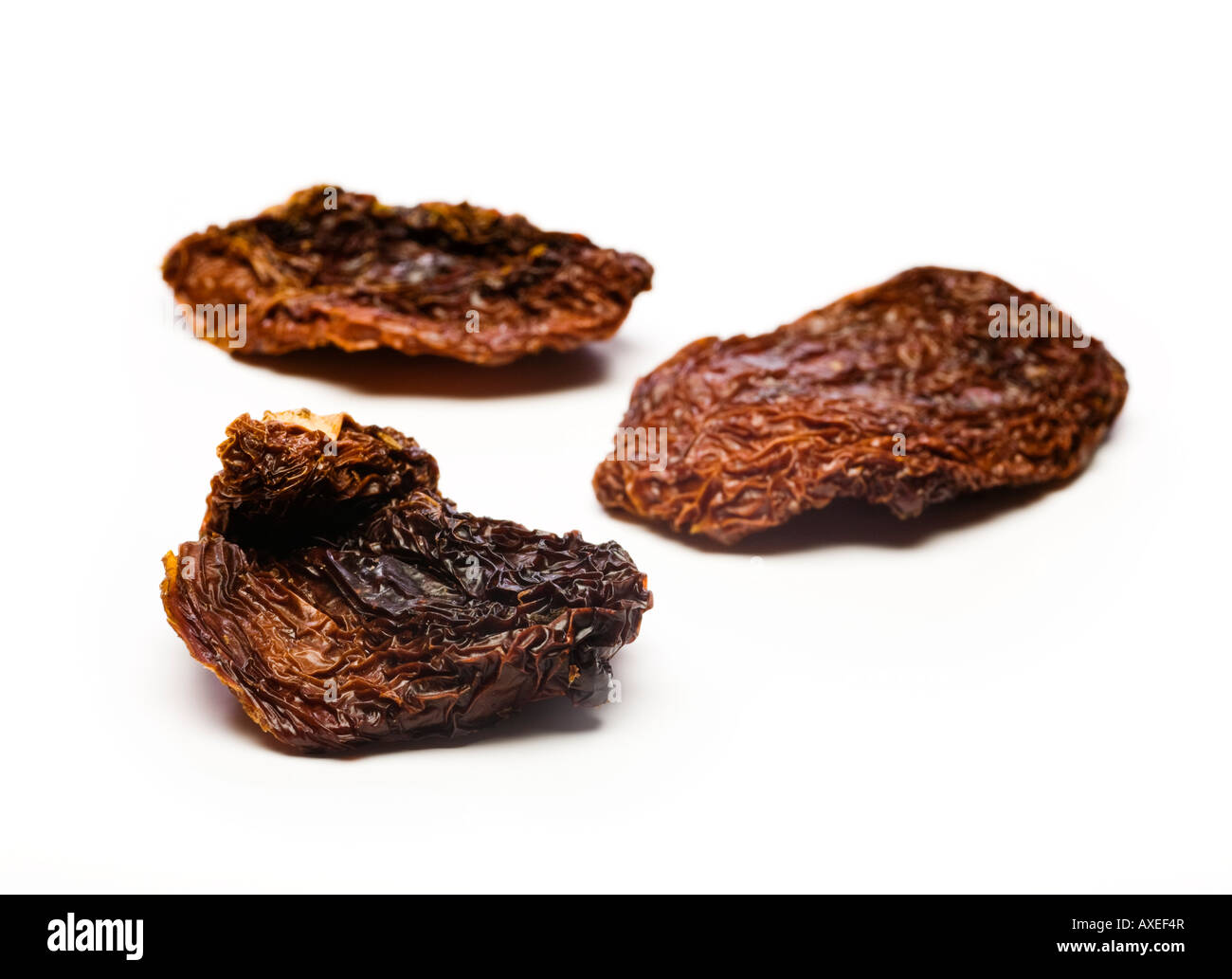 Tre pomodori seccati al sole vicino fino Foto Stock