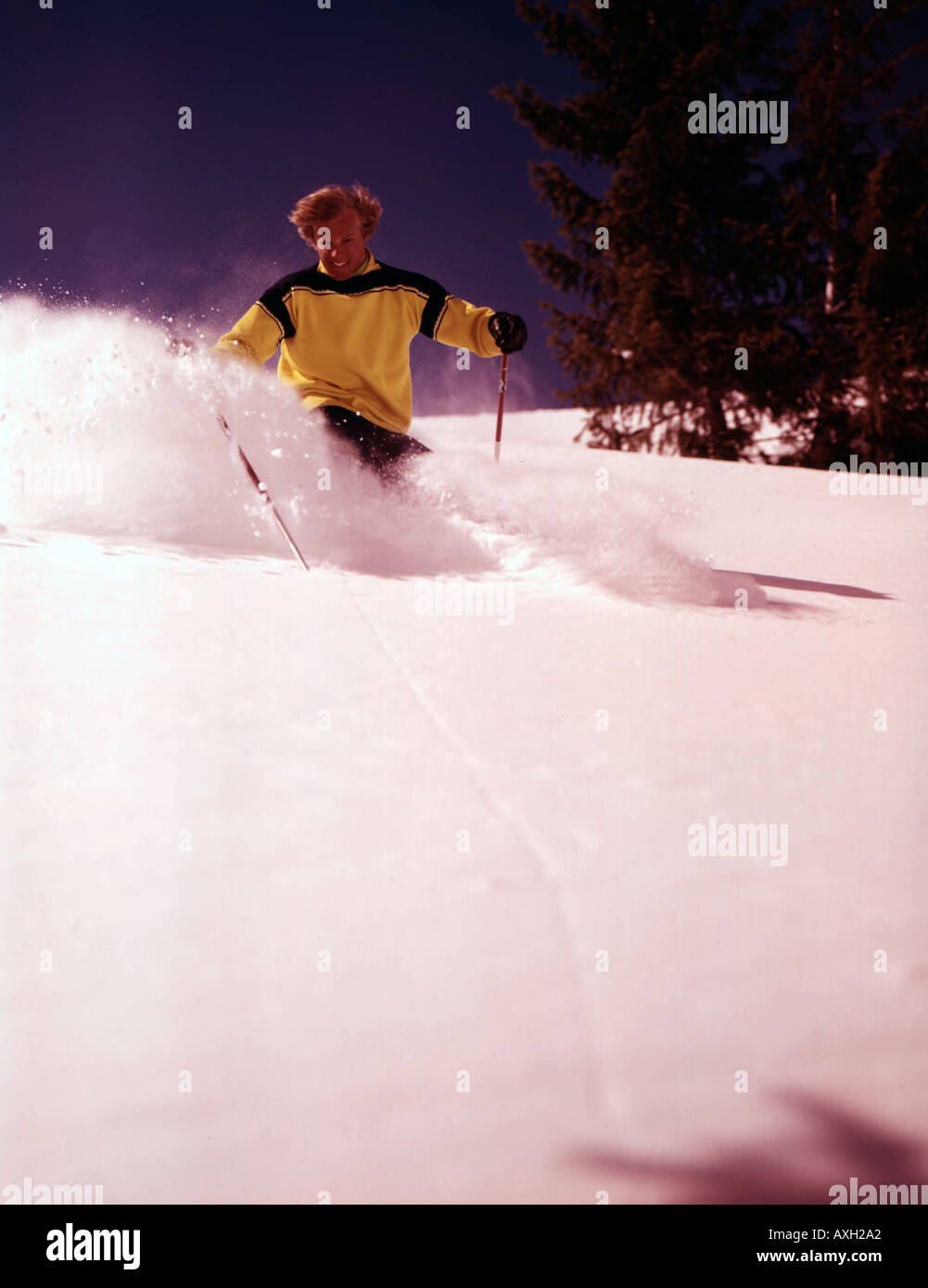 Nuova neve vola dietro un giovane sciatore a Sun Valley Ski Resort in Idaho Foto Stock