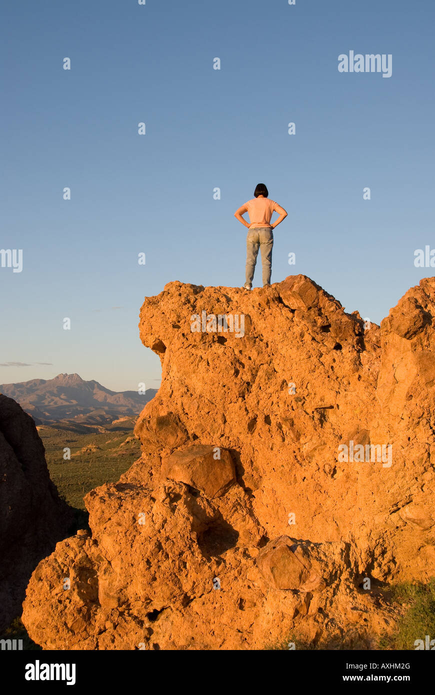 Una donna rende alla sommità di un 2 500 piedi picco di montagna Foto Stock