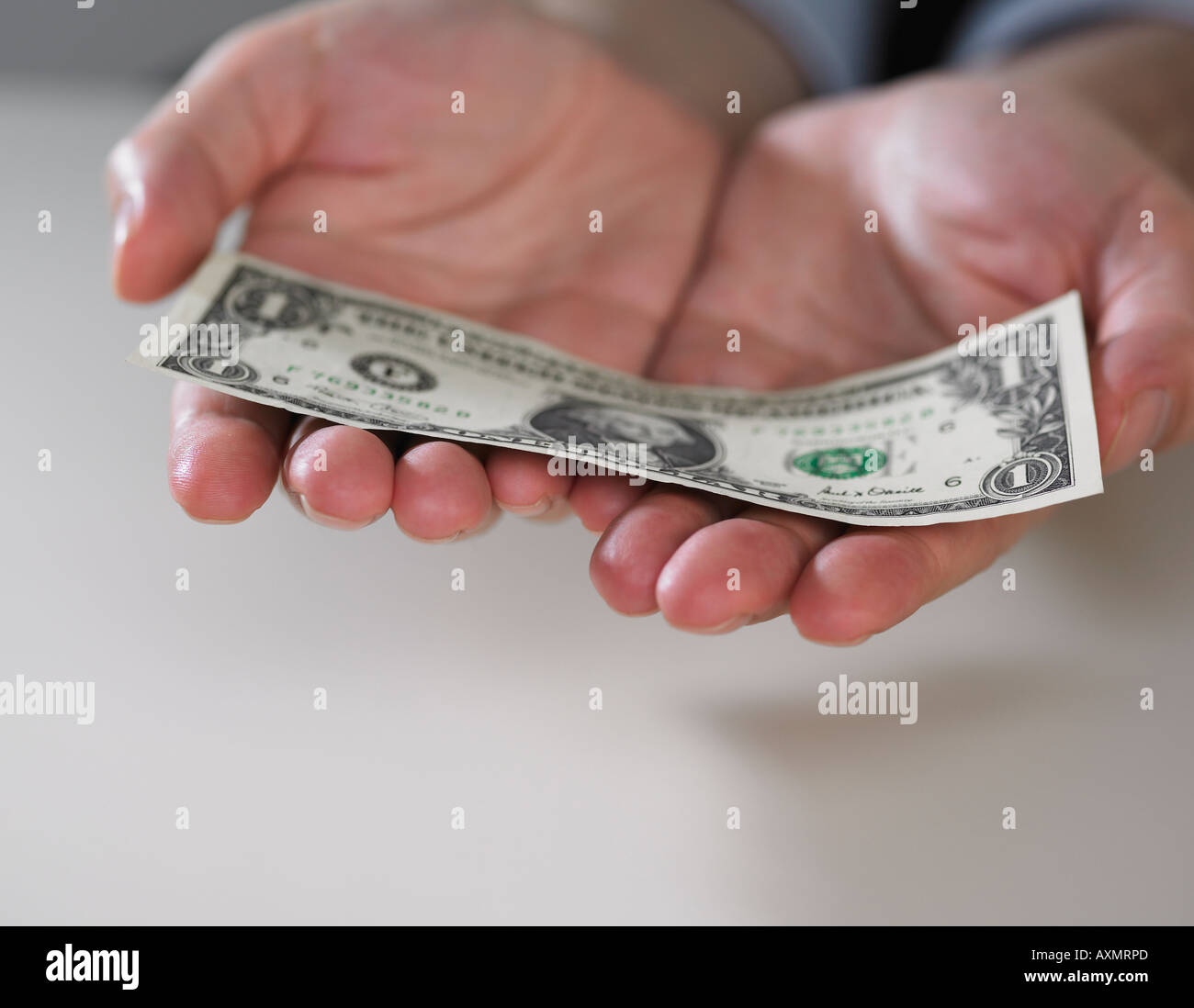 Le mani sono in possesso di un dollaro americano Bill Foto Stock