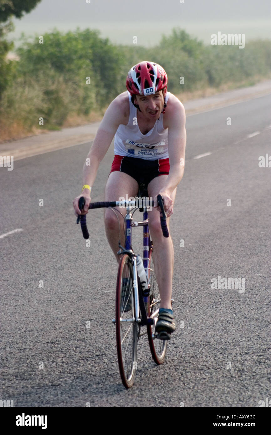 Concorrente maschile durante le escursioni in bicicletta gamba del Wakefield Triathlon 2006 mostra fatica sul viso Foto Stock