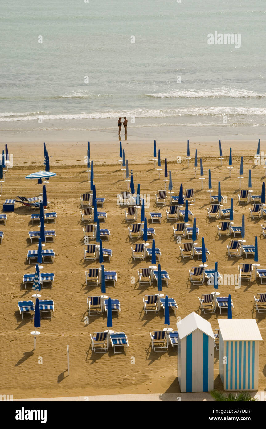 Spiaggia tranquilla con Beach Hut, un ombrello aperto e due persone a bordo, Jesolo, Veneto, Italia, Europa Foto Stock