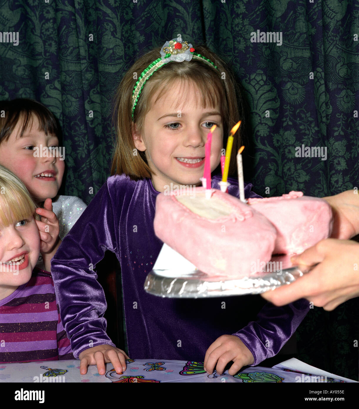 Compleanno ragazza gettting pronto a soffiare le quattro candele Foto Stock