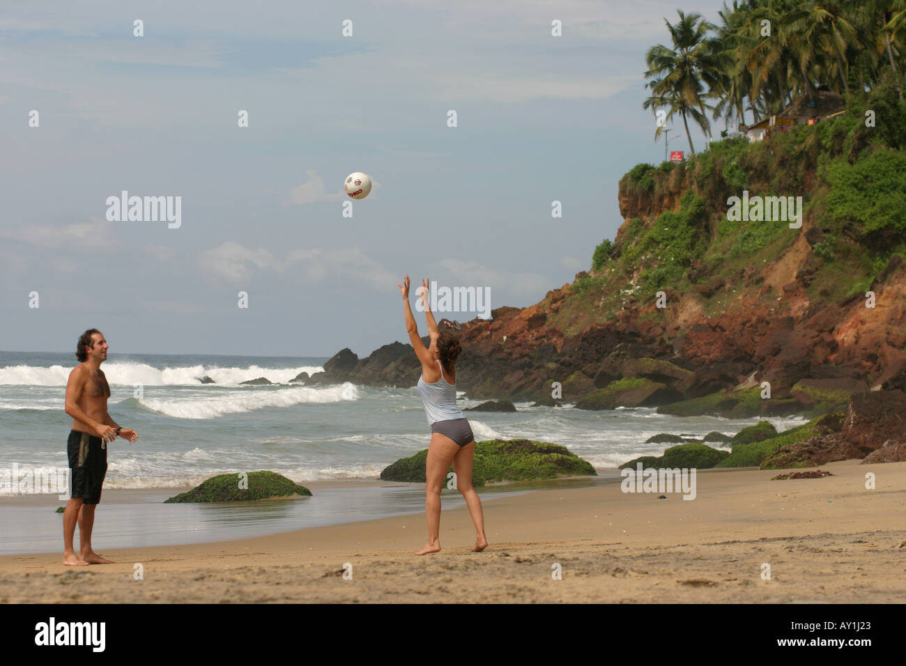 Coppia giovane a giocare a beach volley sulla spiaggia di Varkala Kerala, India Foto Stock