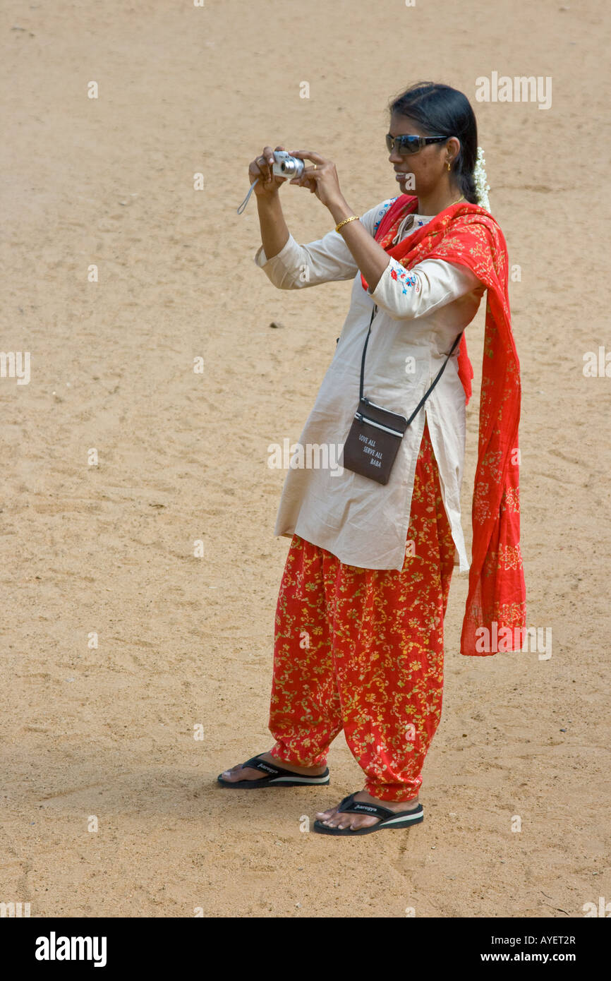 Donna indiana di scattare una foto con una fotocamera digitale a cinque Rathas Mamallapuram in India del Sud Foto Stock