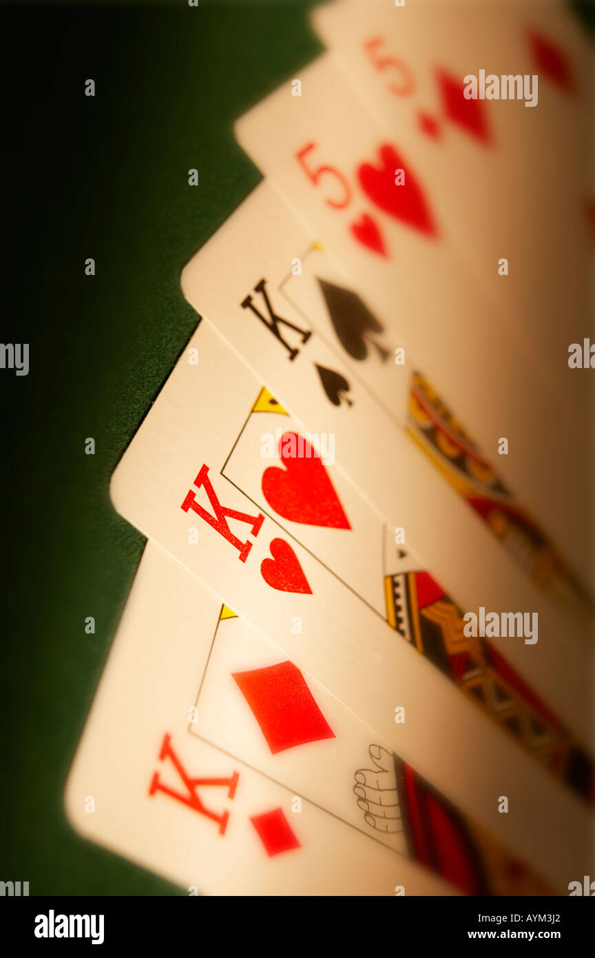 Mano di carte da gioco che mostra il FULL HOUSE sul panno verde tavolo da gioco Foto Stock