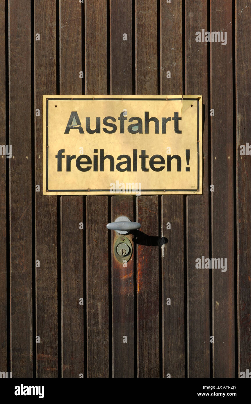 Ausfahrt freihalten (non bloccare l'ingresso) segno inviato su una porta di garage Foto Stock