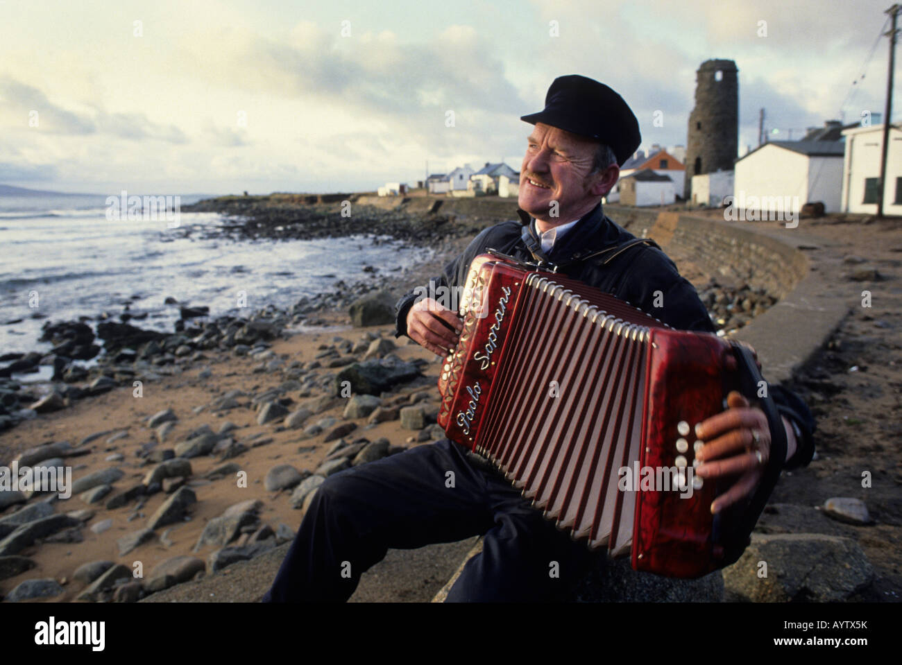 Patsy Dan Rodgers, re di Tory Island, County Donegal, Irlanda. Egli svolge il suo formare fisarmonica sulla riva del mare Foto Stock