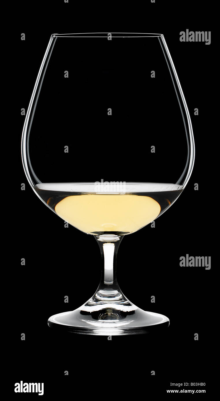 Il brandy di vetro con liquido dorato Foto Stock