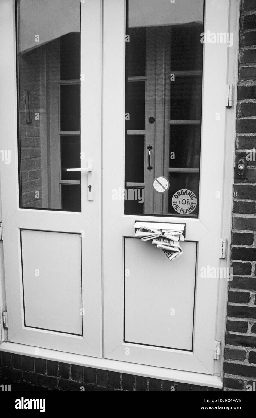 Sportello anteriore letterbox piena zeppa di quotidiani si consiglia di annullare tutte le consegne a domicilio mentre sono in vacanza Foto Stock