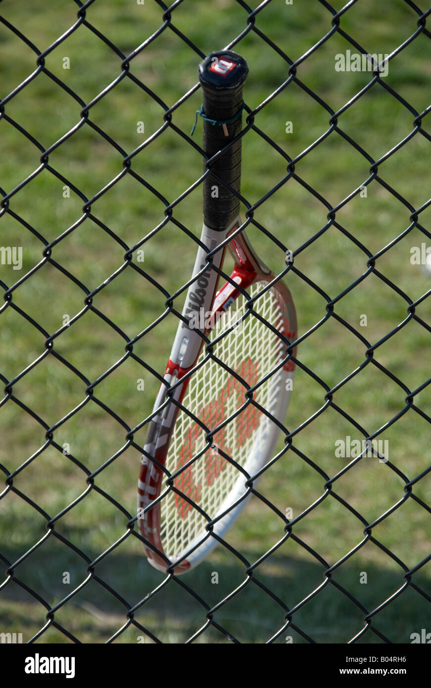 Racchetta da tennis è bloccato in un recinto Foto Stock