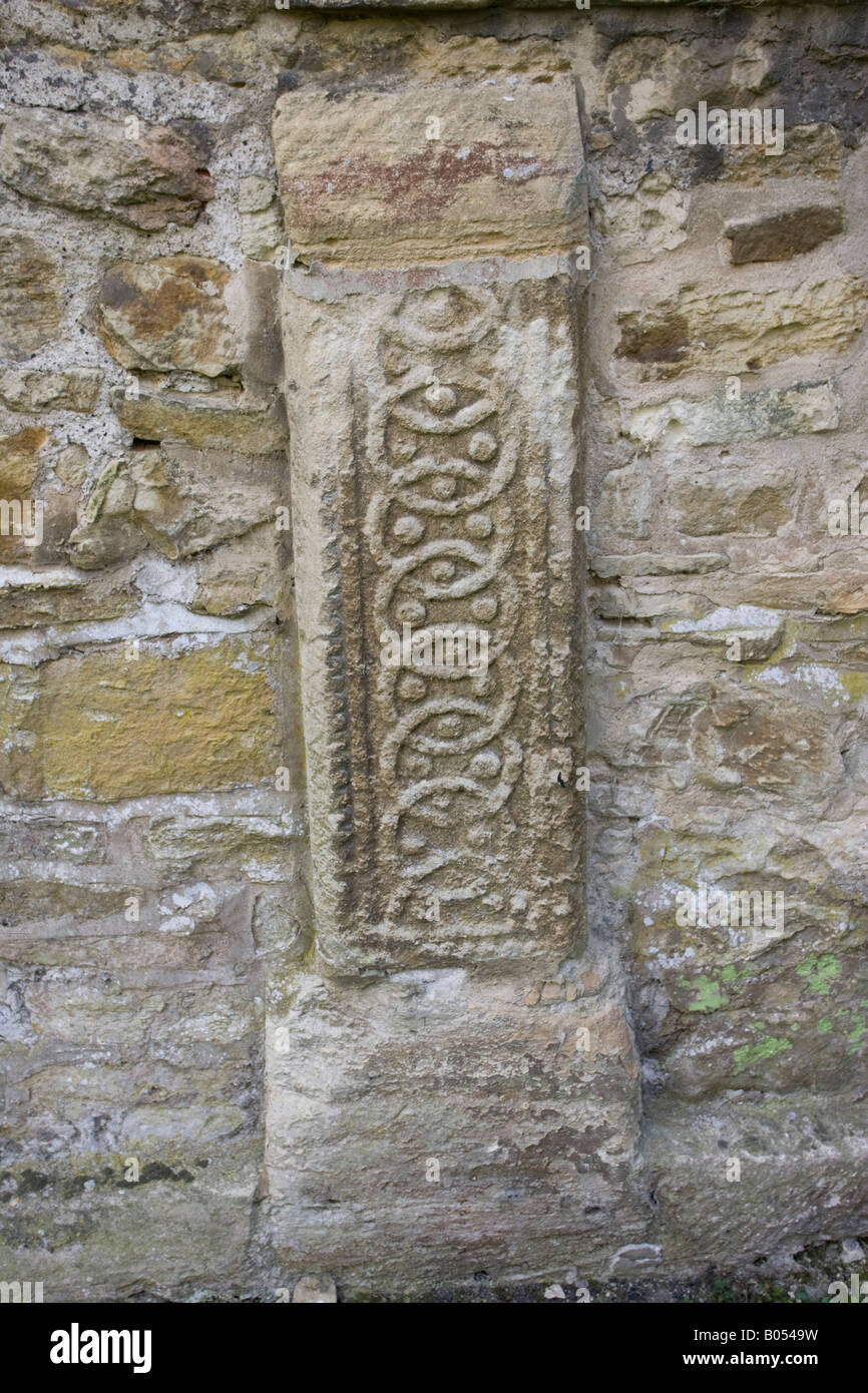Antico Sassone lapide annegata nella parete St Mary chiesa Cotswolds Bibury Regno Unito Foto Stock