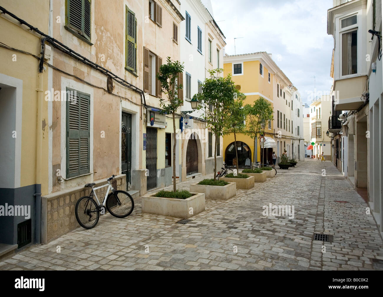 Una strada di ciottoli con le sue case color pastello in antico e storico, ex capitale di Minorca isole Baleari Foto Stock