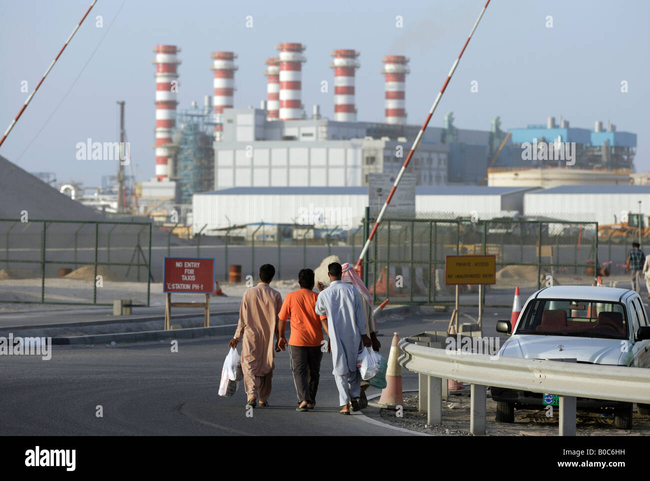 Gli uomini arabi sul loro modo al DEWA Power Station, Dubai, Emirati Arabi Uniti Foto Stock