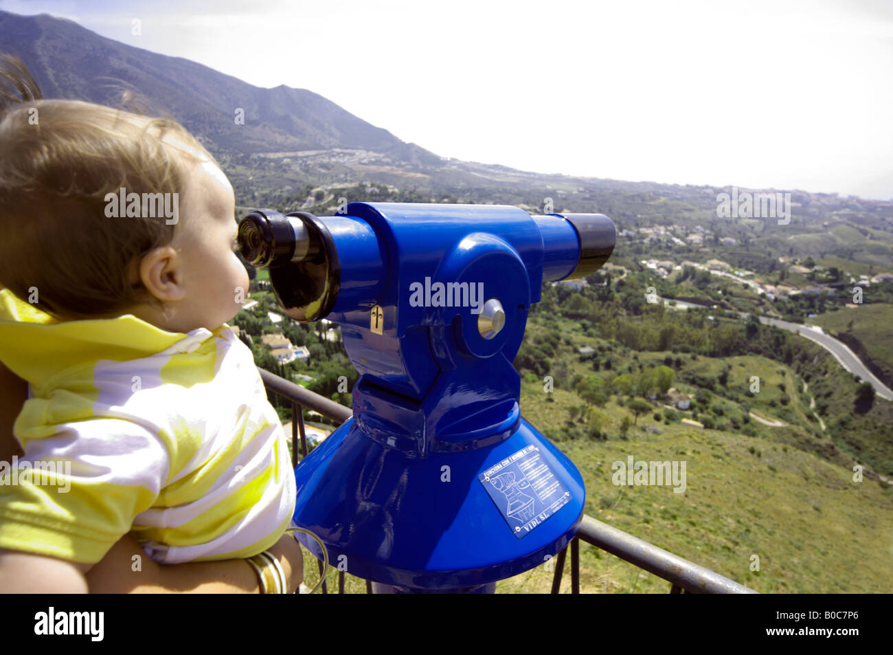 Il Toddler guardando attraverso un telescopio, Mijas Costa del Sol Andalucía, Spagna Foto Stock