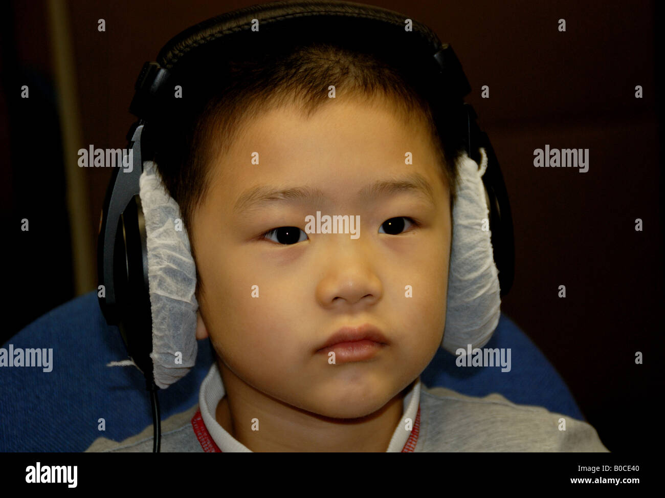 Un ragazzo guarda il filmato nella libreria， Foto Stock