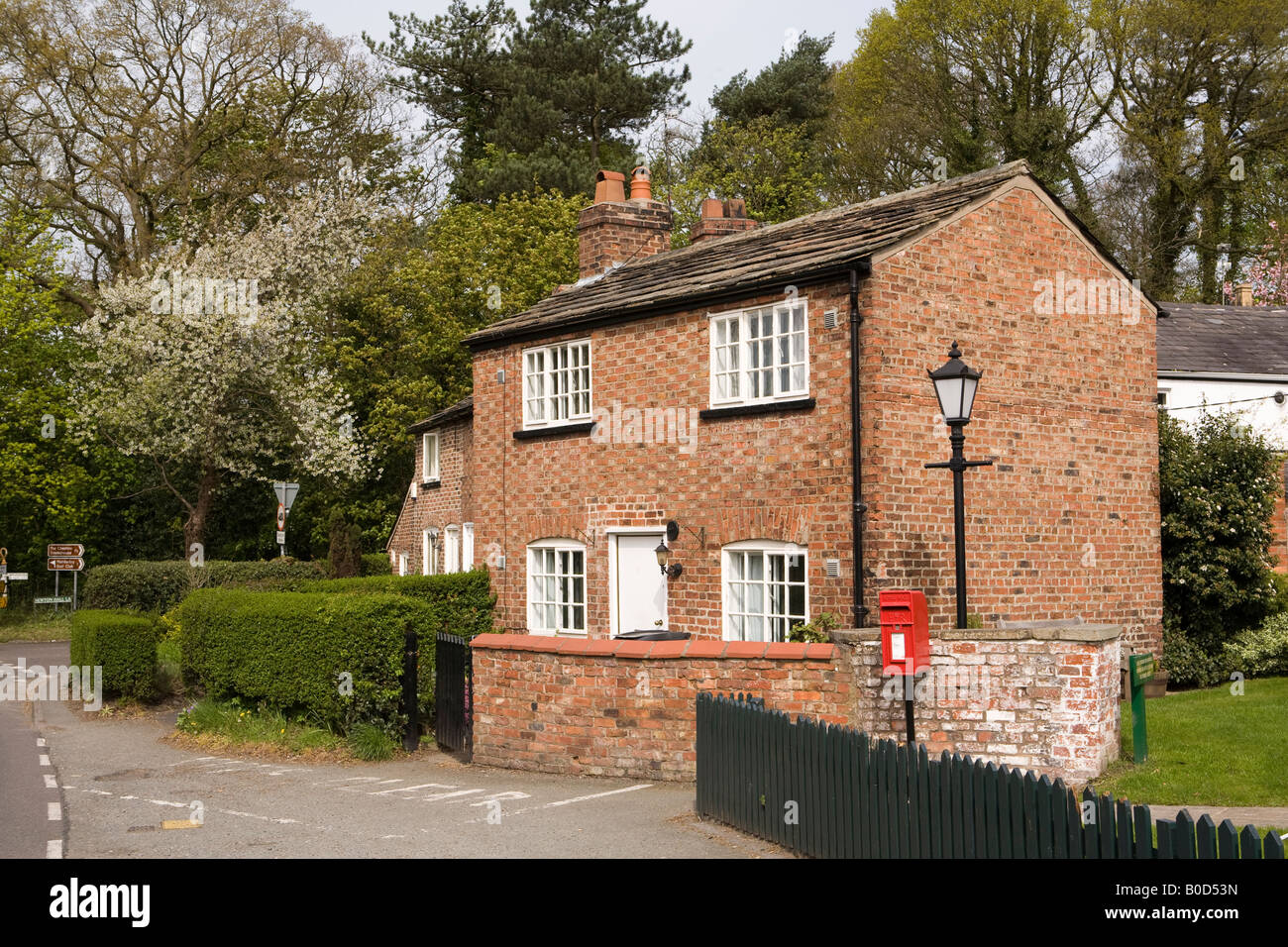 Regno Unito Cheshire Mobberley Knutsford Road rural post box esterno costruito in mattoni cottages Foto Stock