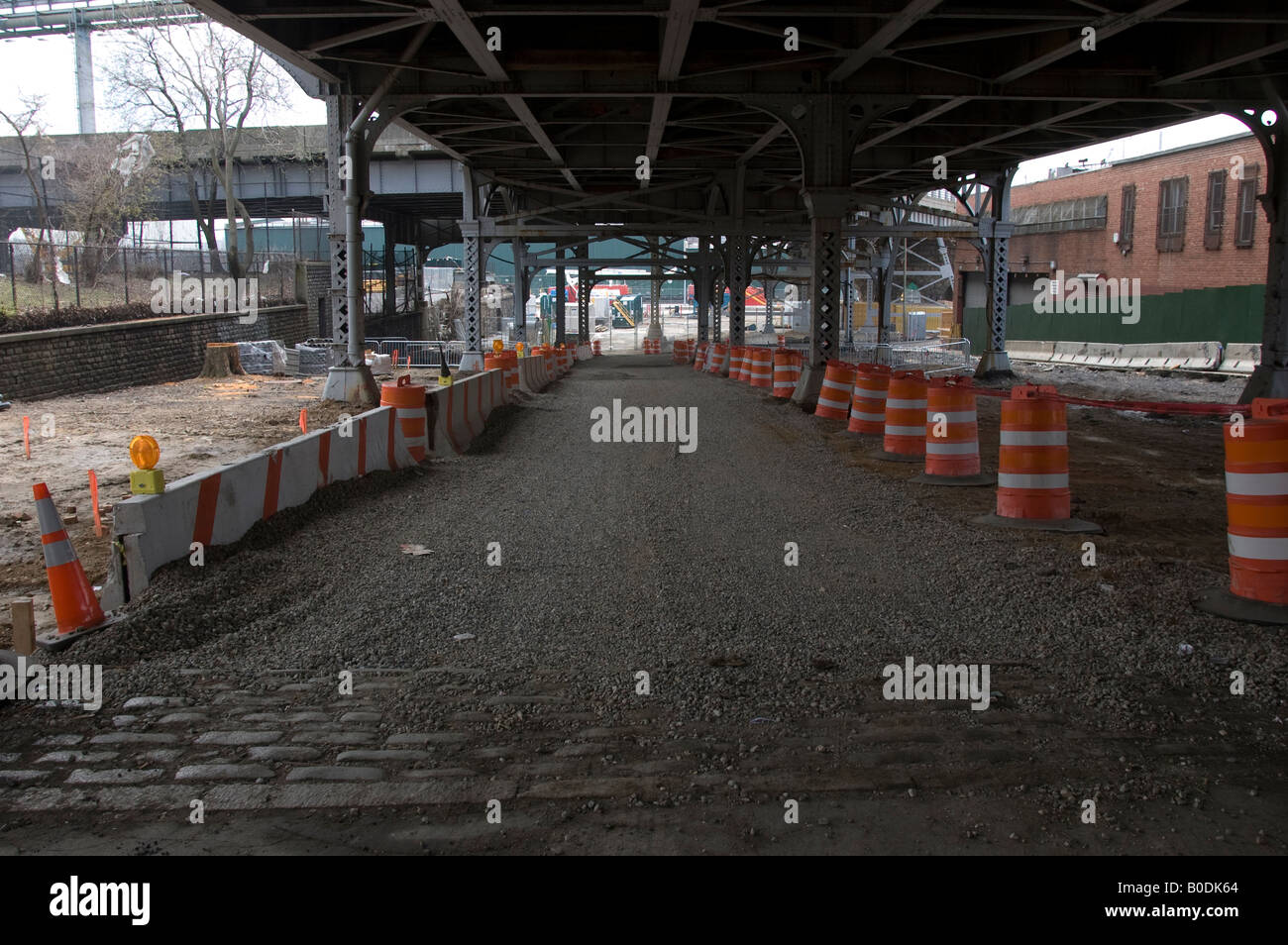 Un lastricato di ghiaia strada di servizio sotto la Bruckner Expressway in Mott Haven quartiere di borough del Bronx a New York Foto Stock