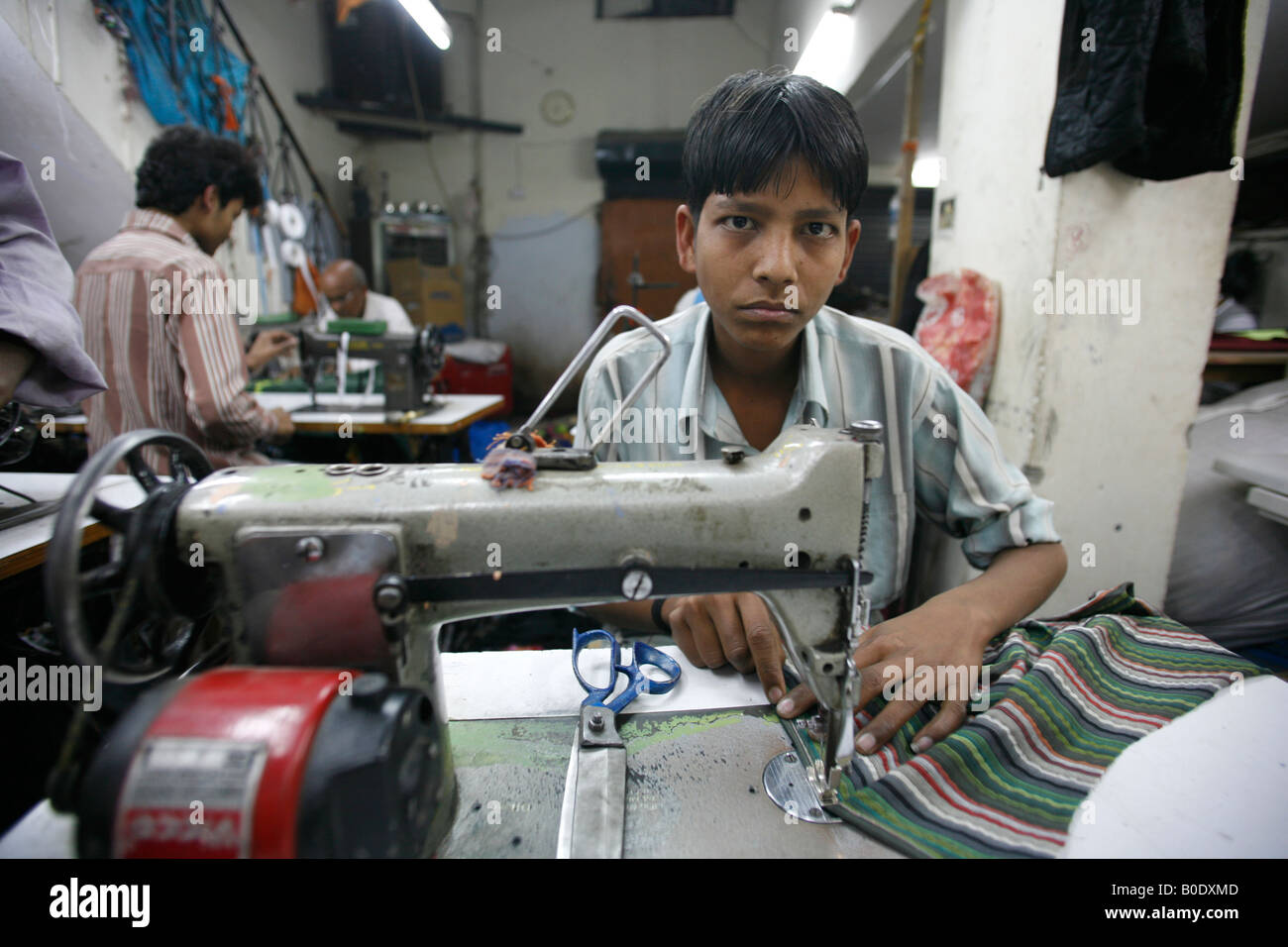 Ragazzo che lavorano in delhi fabbrica tessile india Foto Stock